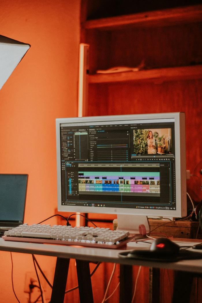 A cozy indoor video editing workspace featuring a computer monitor.